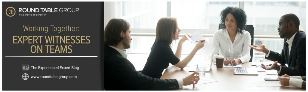 A group of professionals working on a project at a conference table.