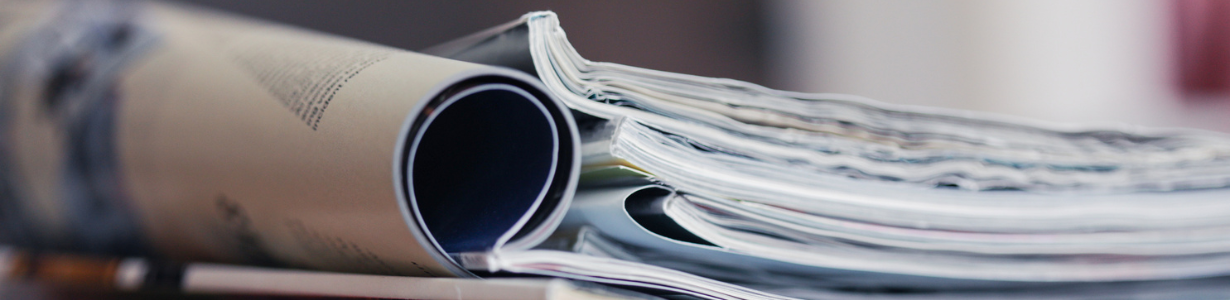 A stack of magazines, close-up macro filled the frame. A background for publishing or informational publications.